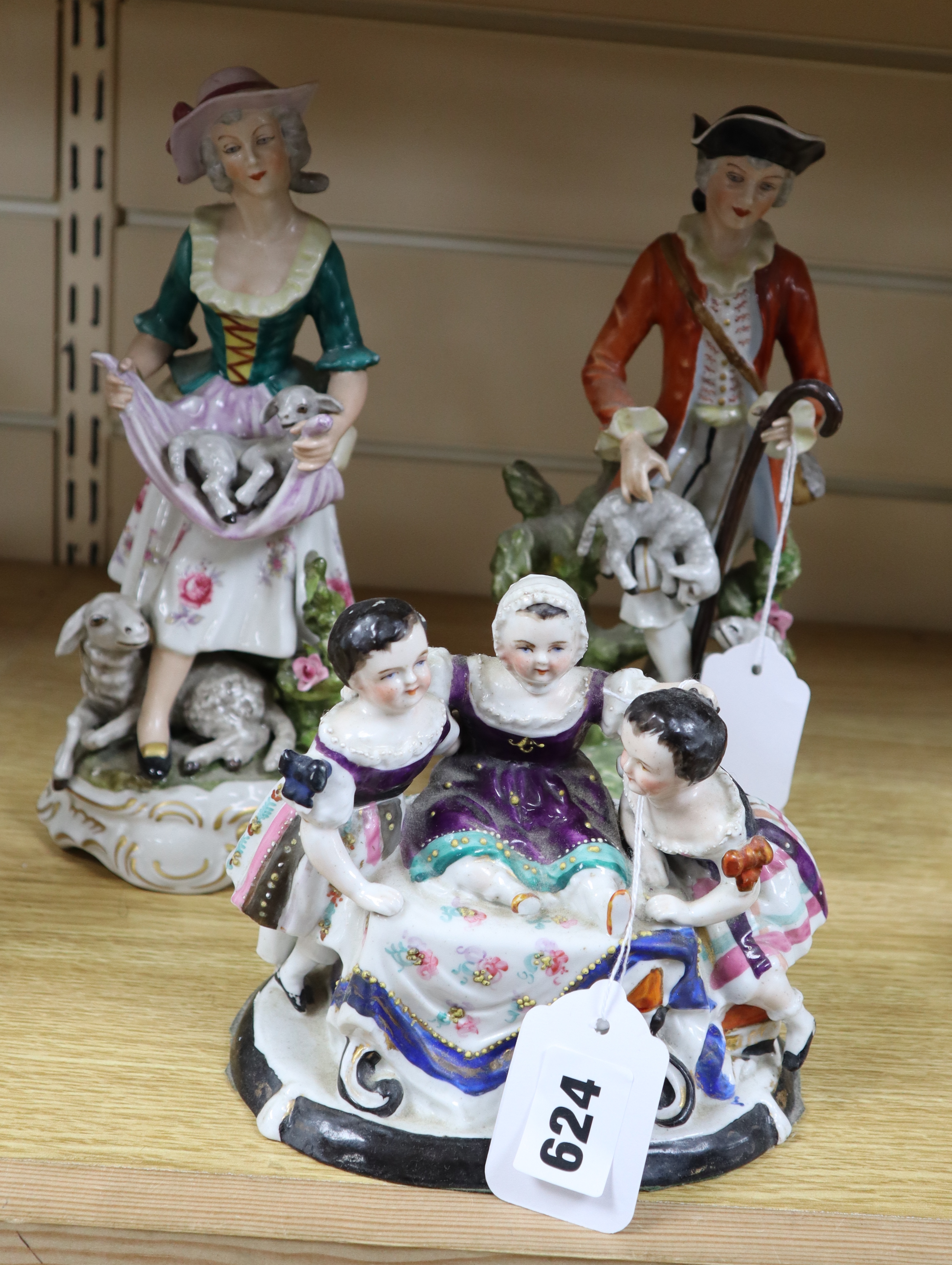 A pair of Meissen style figures of a shepherd and shepherdess and a figural group, tallest 26cm